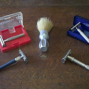 Four Gillette razors and a brush